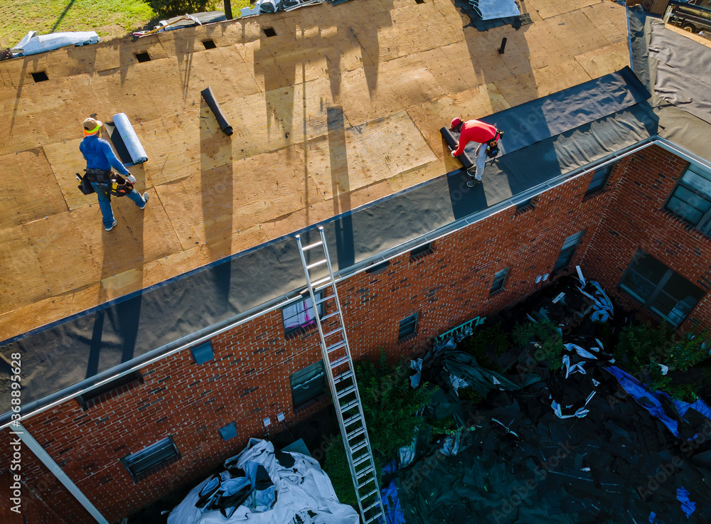 roofers installing a roof aerial view